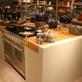The store opens up at the back with a high ceiling and glass and steel staircase, while strong use of colour blocking makes the merchandising stand out